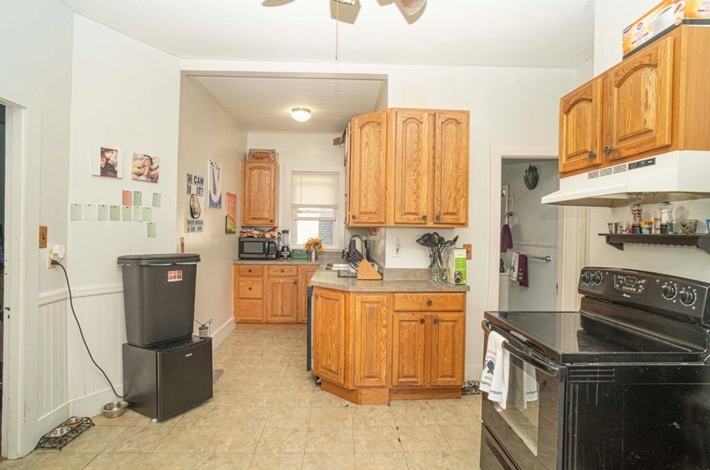 5 Exeter Street Taunton, MA 02780 - Photo 4 of 32 a kitchen with stainless steel appliances granite countertop a stove a sink and a refrigerator