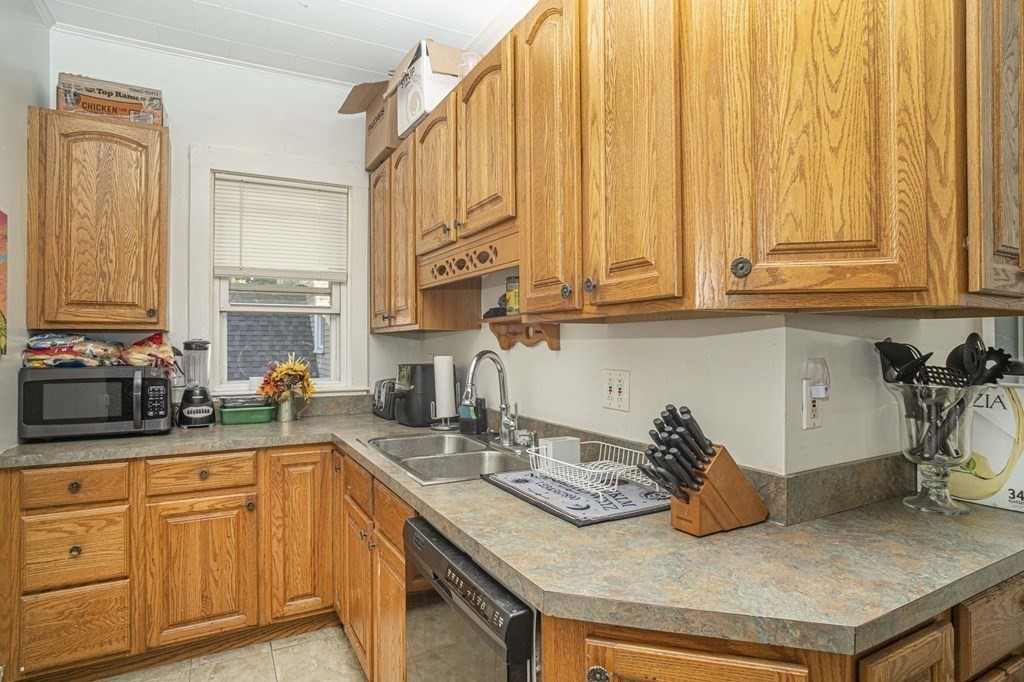 5 Exeter Street Taunton, MA 02780 - Photo 5 of 32 a kitchen with stainless steel appliances granite countertop a sink a stove and cabinets