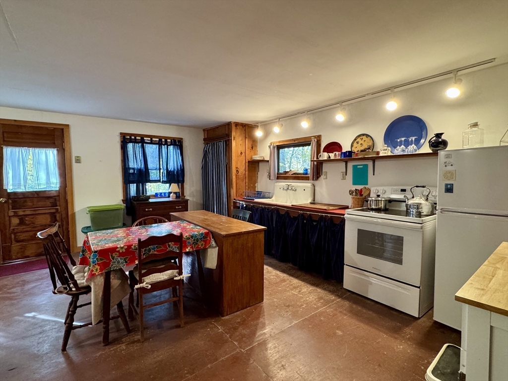 246 S Road Heath, MA 01346 - Photo 4 of 14 a open kitchen with stainless steel appliances granite countertop a stove a sink a refrigerator and a dining table with wooden floor