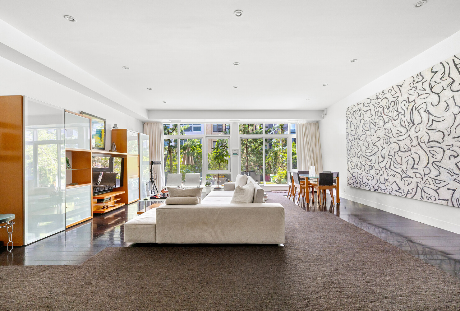 111 Fulton Street, Unit PH111 Manhattan, NY 10038 - Photo 3 of 12 a living room with furniture and a flat screen tv