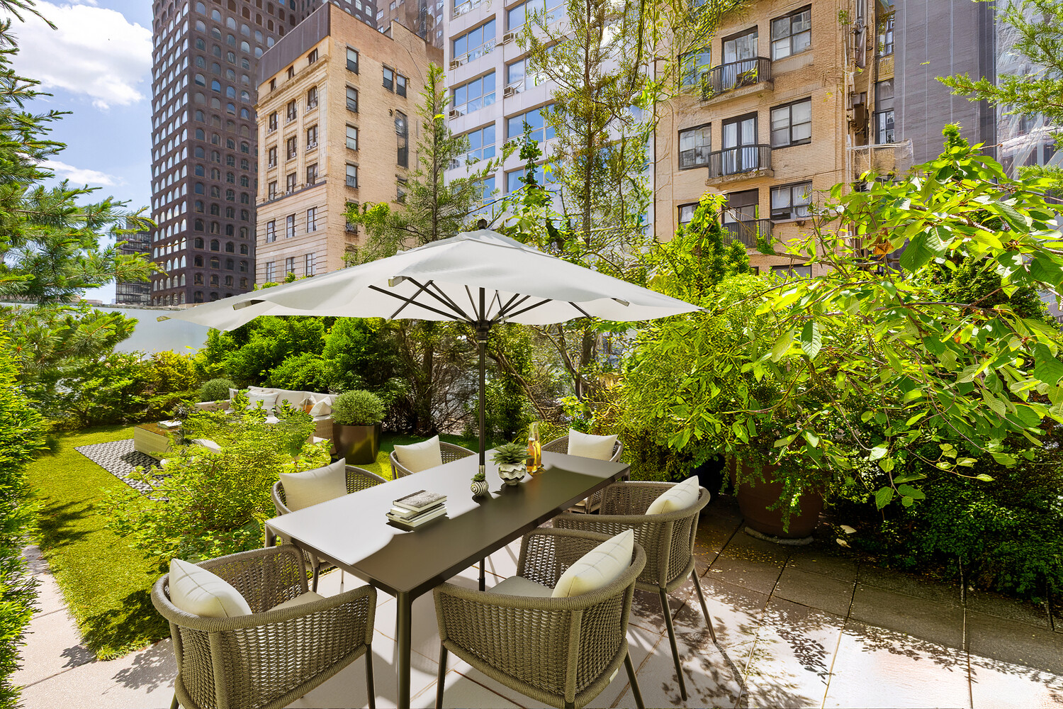111 Fulton Street, Unit PH111 Manhattan, NY 10038 - Photo 4 of 12 a view of a patio with table and chairs under an umbrella