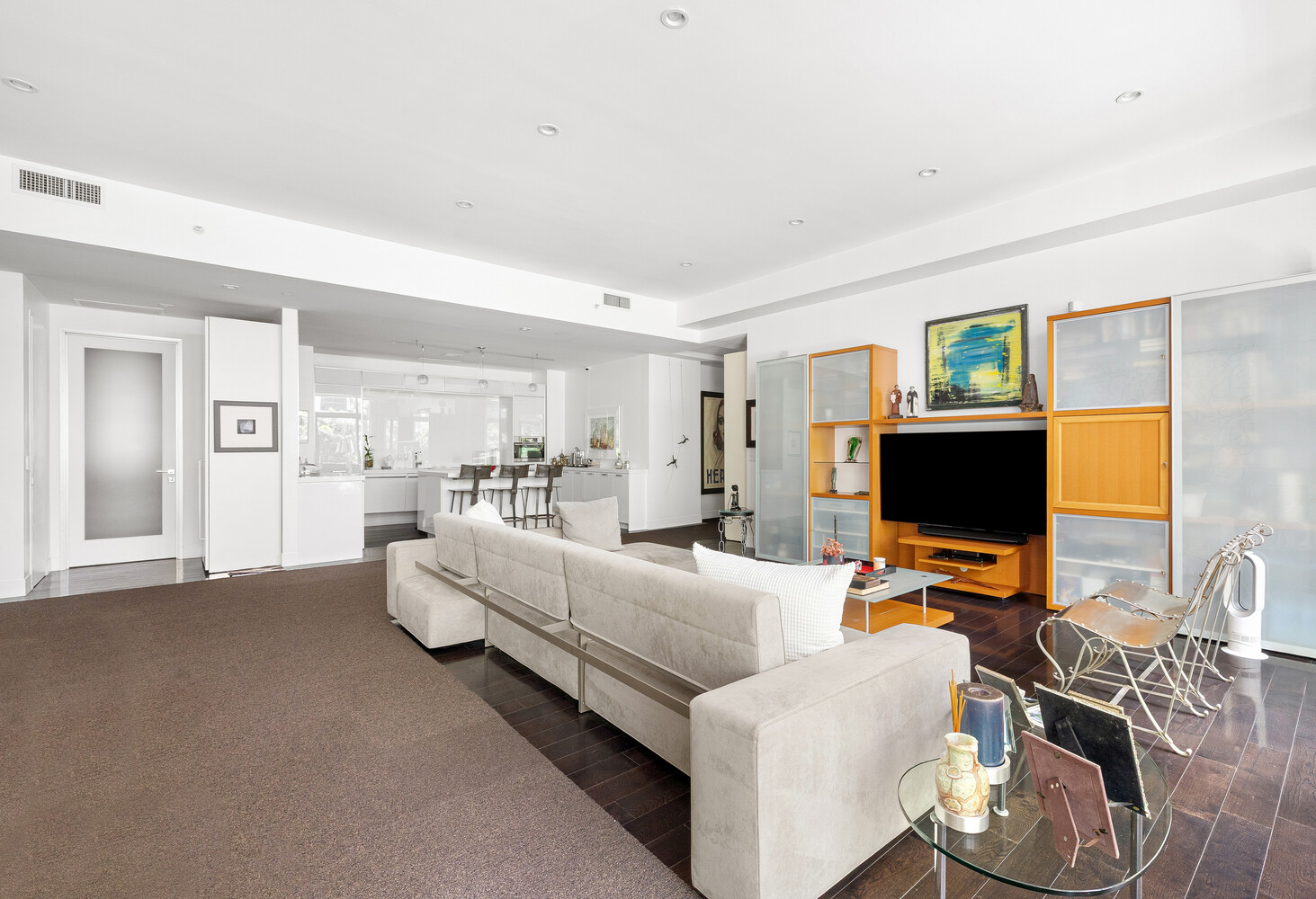 111 Fulton Street, Unit PH111 Manhattan, NY 10038 - Photo 5 of 12 a living room with furniture and a flat screen tv