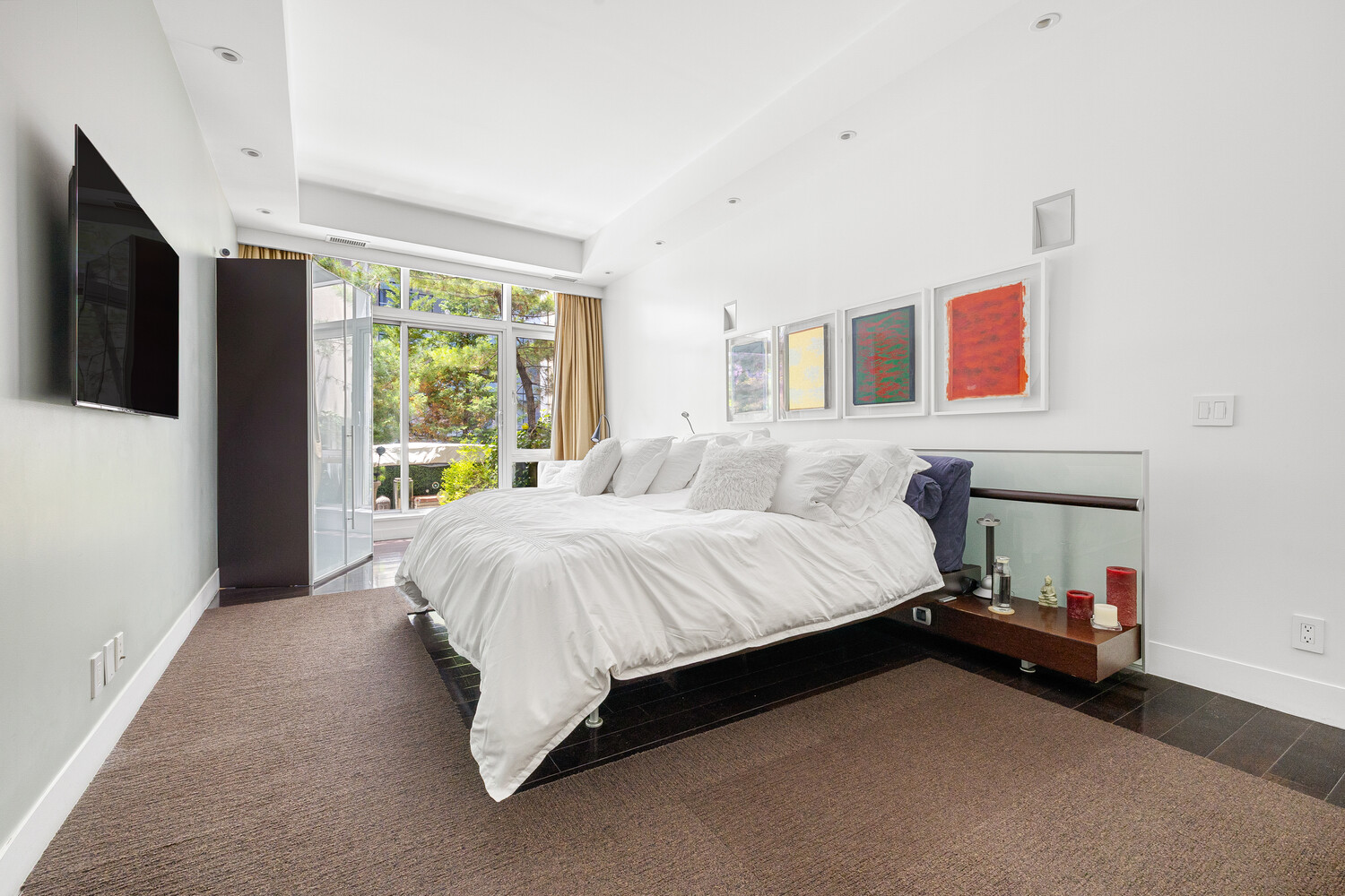 111 Fulton Street, Unit PH111 Manhattan, NY 10038 - Photo 7 of 12 a spacious bedroom with a bed and a flat tv screen