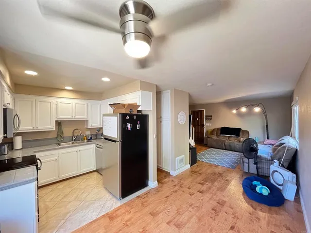 a kitchen with stainless steel appliances kitchen island granite countertop a refrigerator and stove