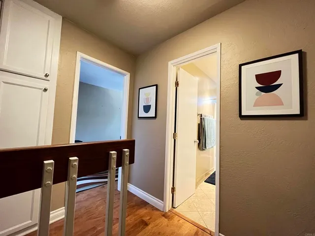 a view of a hallway with paintings on the wall