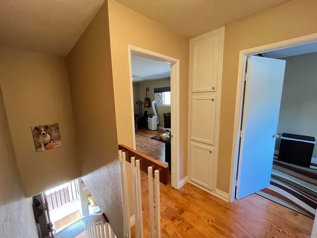 a view of a hallway to a livingroom with furniture