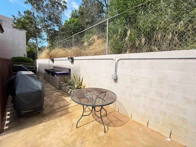 a backyard of a house with table and chairs