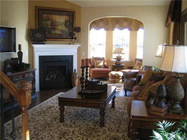 8331 Yaxley Hall Drive, Unit 628 Raleigh, NC 27616 - Photo 2 of 11 MODEL PICTURE- Sunroom is extended off family room with corner fireplace.
