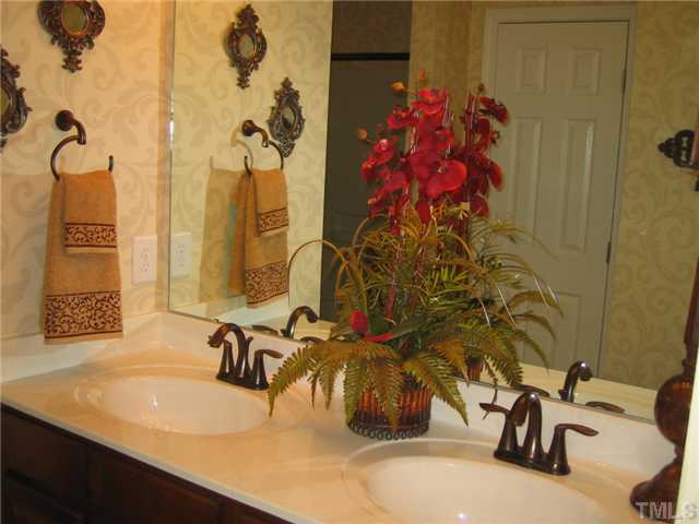 8331 Yaxley Hall Drive, Unit 628 Raleigh, NC 27616 - Photo 6 of 11 Dual vanities, WIC with separate linen closet, and oversized shower with corner seats