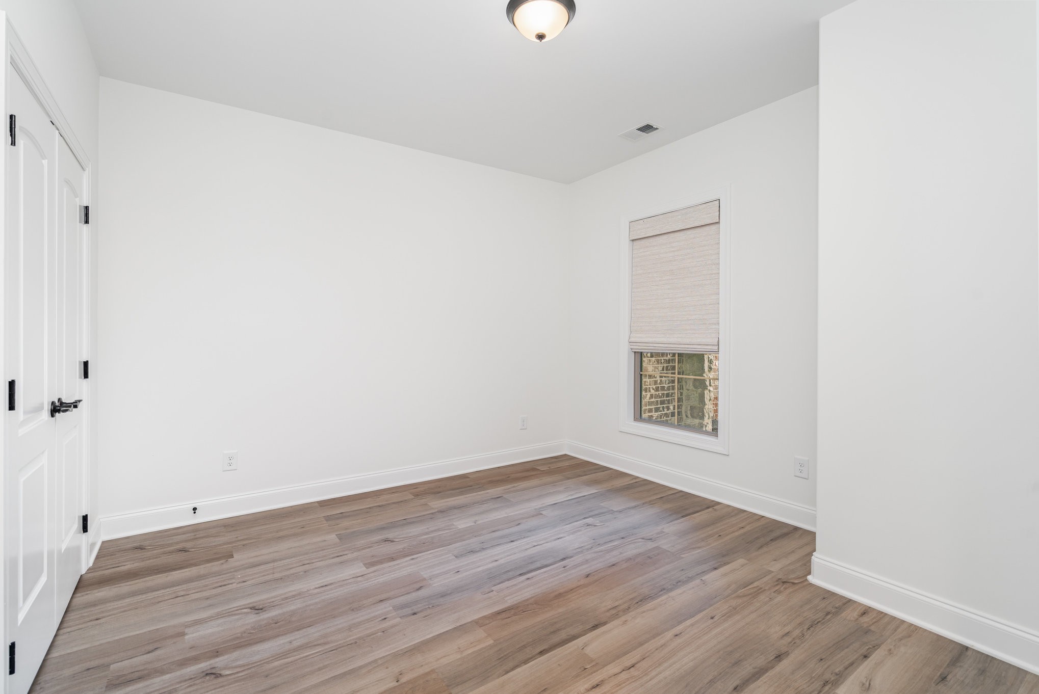 412 West Foxrun Springfield, TN 37172 - Photo 18 of 23 a view of an empty room with wooden floor and a window