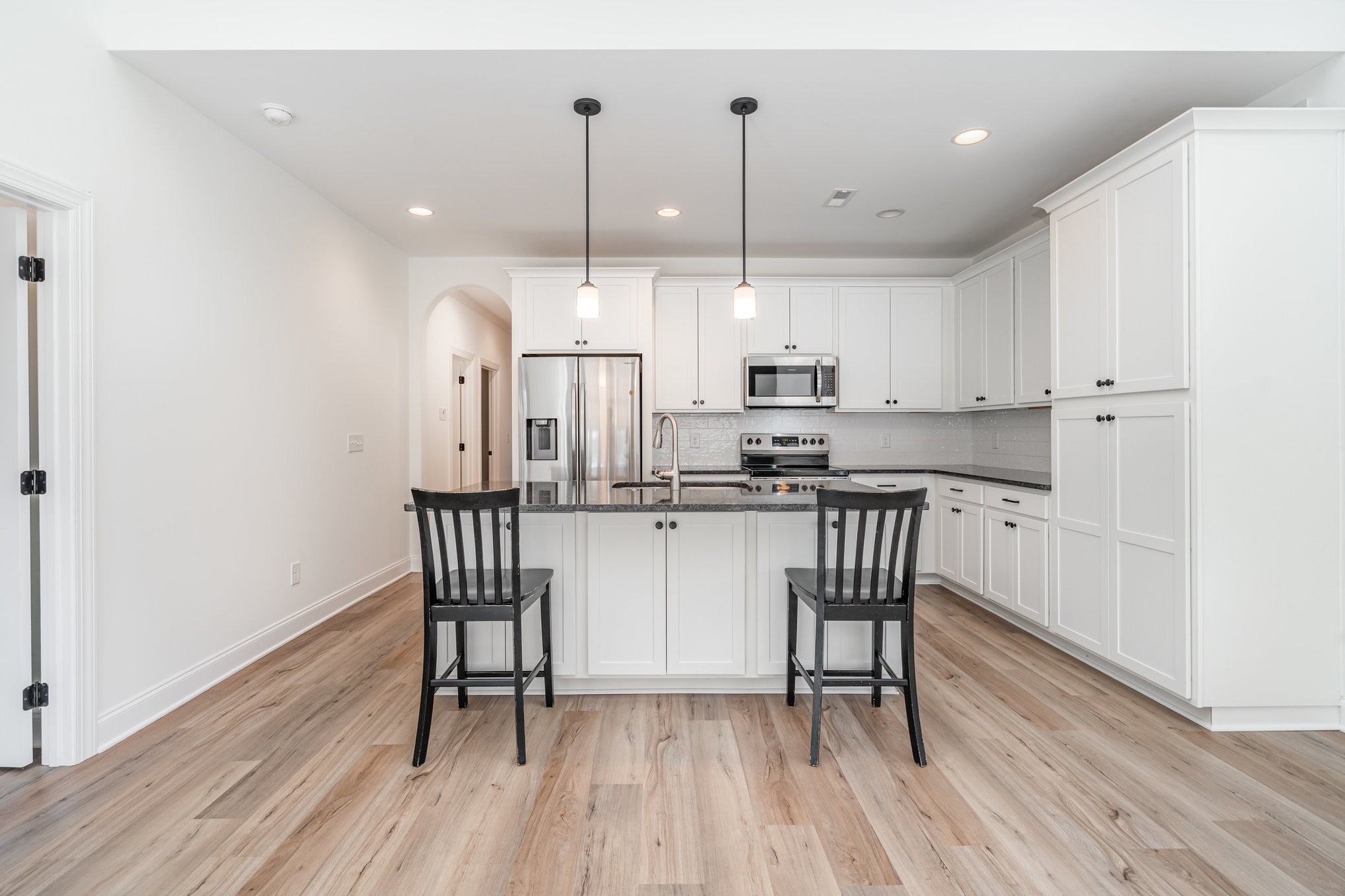 412 West Foxrun Springfield, TN 37172 - Photo 5 of 23 a kitchen with stainless steel appliances granite countertop a stove a sink a refrigerator and white cabinets with wooden floor