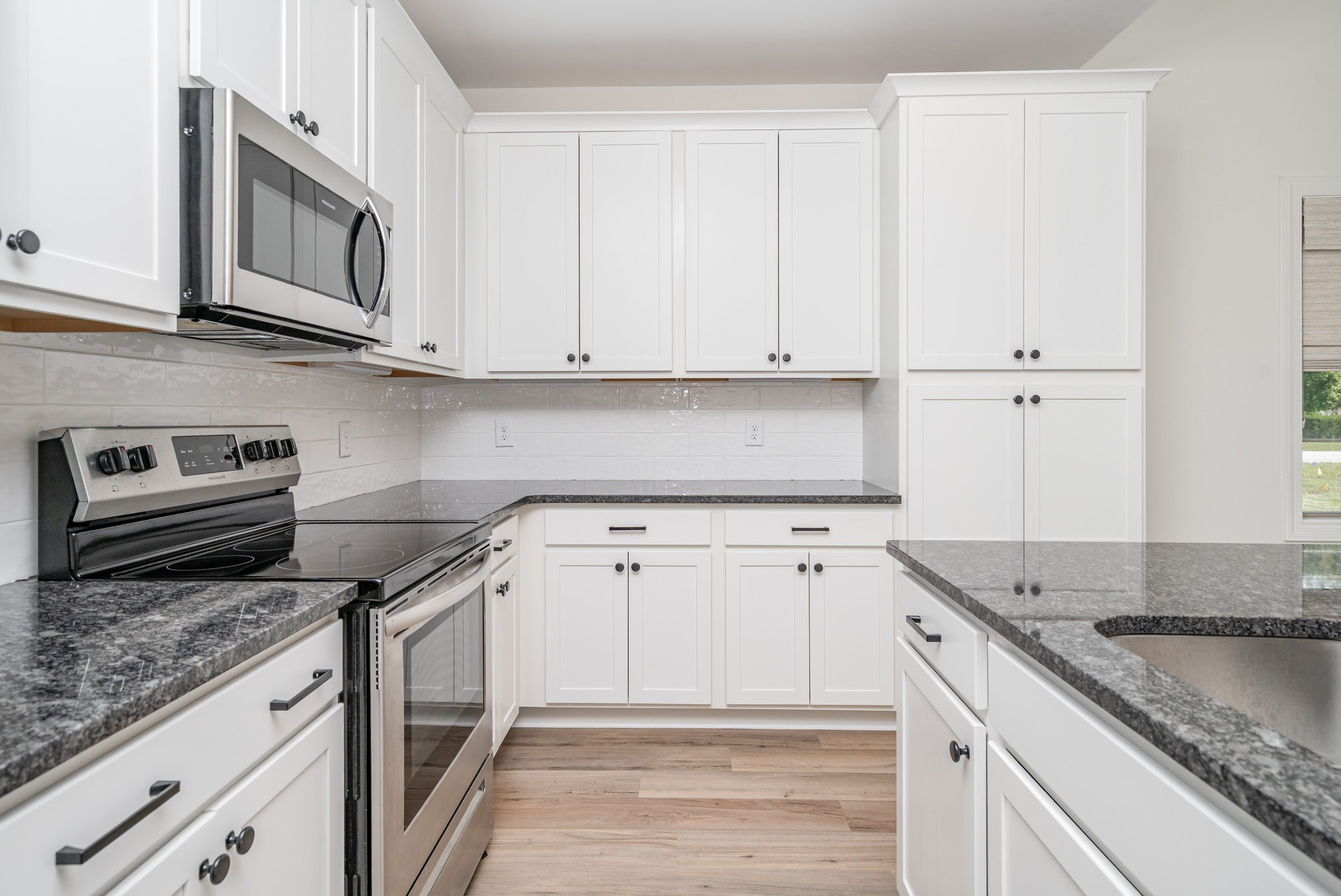412 West Foxrun Springfield, TN 37172 - Photo 6 of 23 a kitchen with granite countertop stainless steel appliances white cabinets granite counter tops and a stove