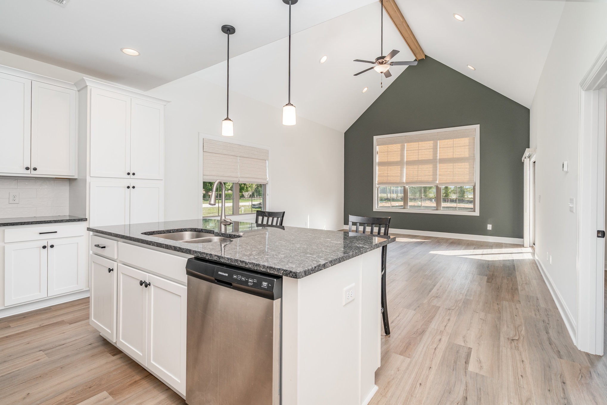 412 West Foxrun Springfield, TN 37172 - Photo 7 of 23 a kitchen with granite countertop a stove a sink and white cabinets with wooden floor