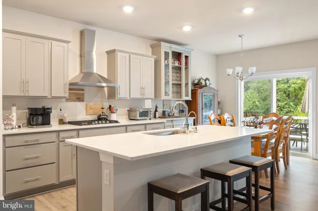 a kitchen with appliances a sink and cabinets
