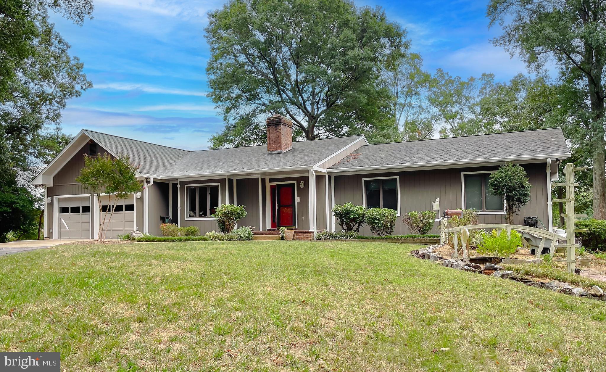 44973 Smiths Nursery Road Hollywood, MD 20636 - Photo 12 of 111 a front view of a house with a yard and trees