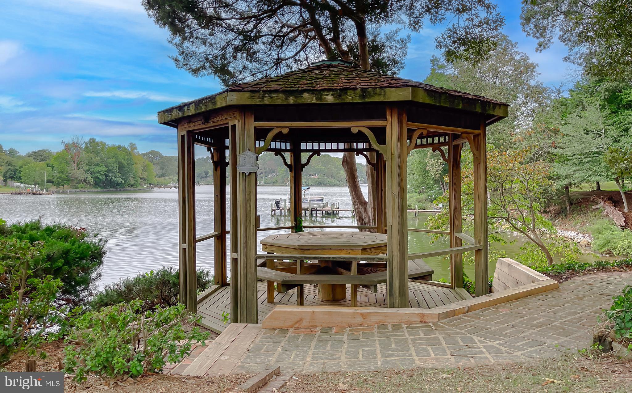 44973 Smiths Nursery Road Hollywood, MD 20636 - Photo 41 of 111 a view of a patio with table and chairs with wooden floor and fence