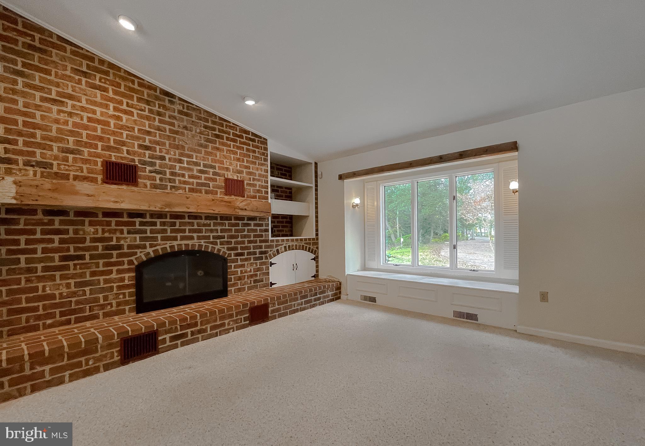44973 Smiths Nursery Road Hollywood, MD 20636 - Photo 81 of 111 a living room with a fireplace and a floor to ceiling window