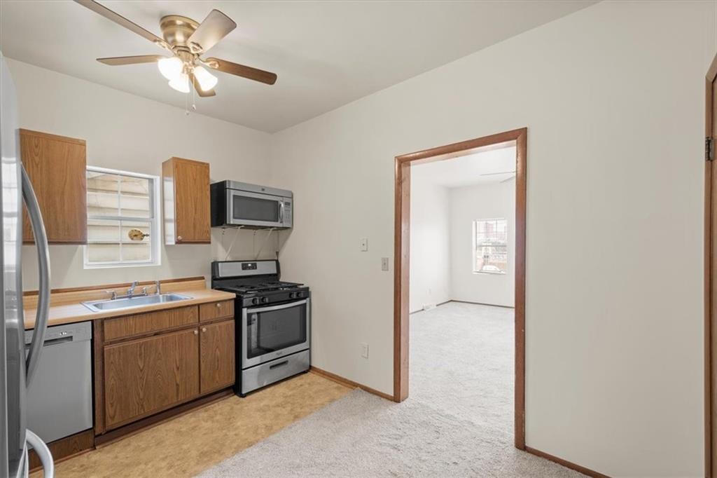 852 Windom Street Pittsburgh, PA 15203 - Photo 17 of 44 a kitchen with a sink stainless steel appliances and cabinets