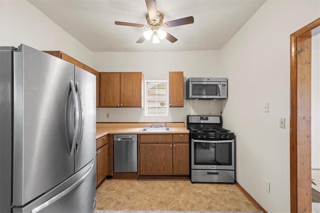 852 Windom Street Pittsburgh, PA 15203 - Photo 18 of 44 a kitchen with stainless steel appliances granite countertop a stove a refrigerator and a sink