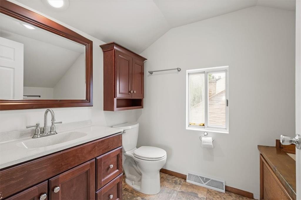 852 Windom Street Pittsburgh, PA 15203 - Photo 28 of 44 a bathroom with a toilet a sink a mirror and a window