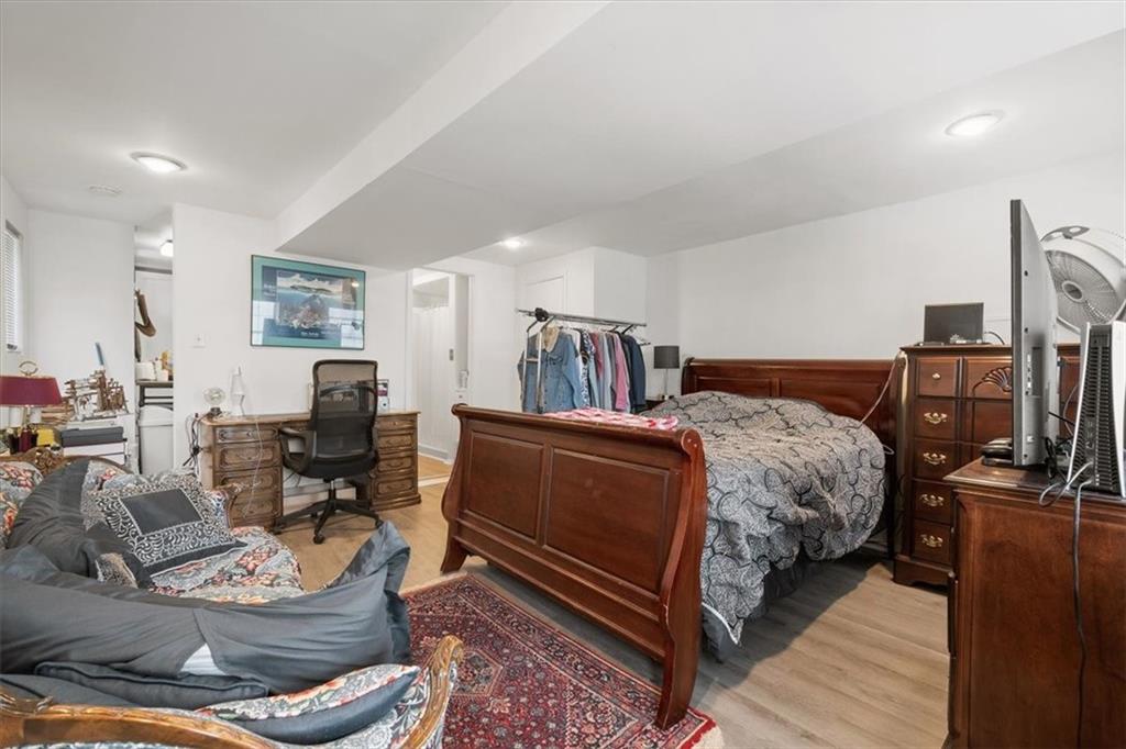 852 Windom Street Pittsburgh, PA 15203 - Photo 34 of 44 a bedroom with a bed and wooden floor