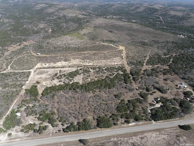 a view of a yard with wooden fence