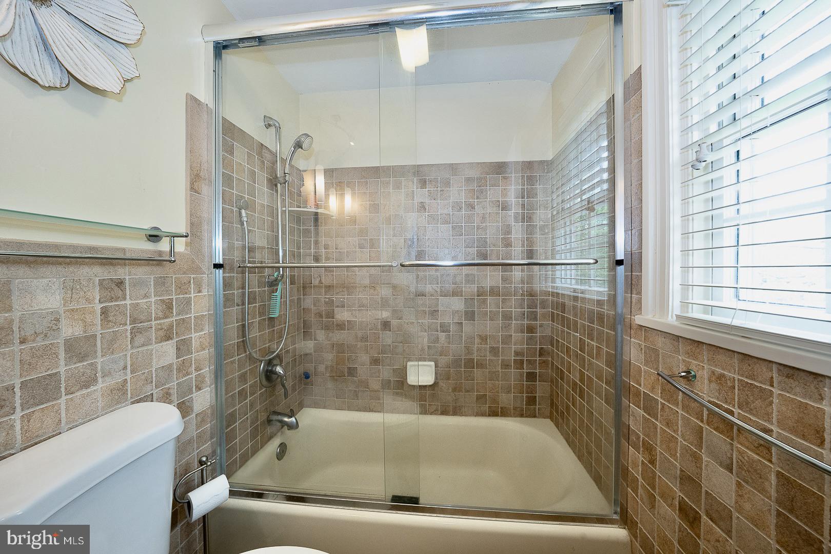 305 Eagle Road Wayne, PA 19087 - Photo 26 of 43 a bathroom with a bathtub and a shower