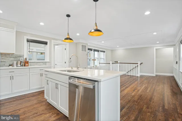a kitchen with a sink cabinets and stainless steel appliances
