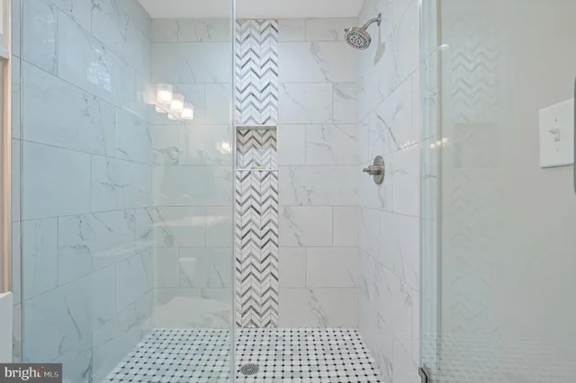 a view of a room with wooden floor electronic appliances and windows