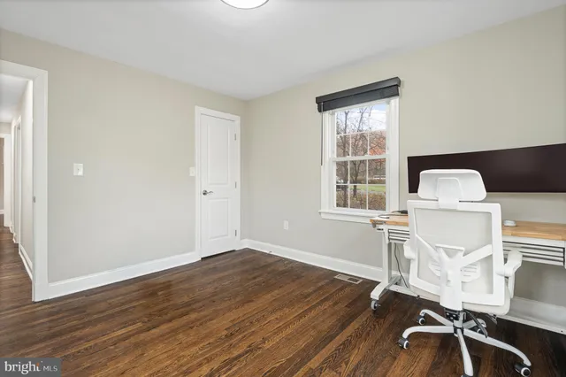 a view of a small space with wooden floor and a window