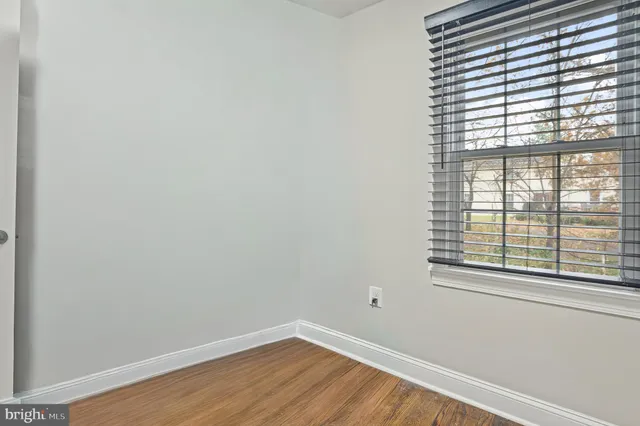 a view of a hallway with wooden floor and stairs