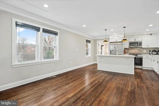 a view of wooden floor and windows in a room