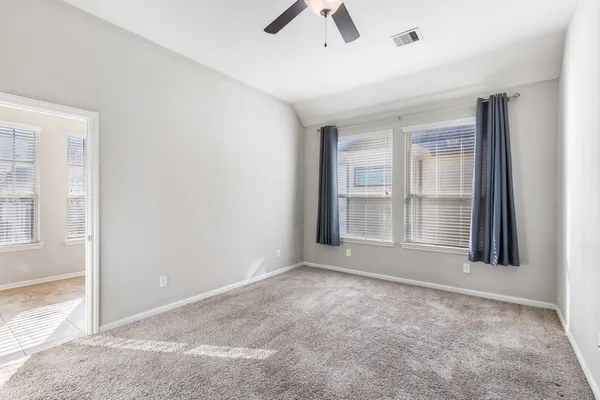 a bedroom with a bed and painting on the wall