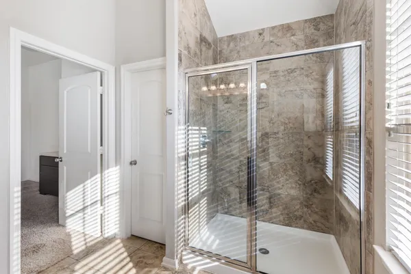 a bathroom with a granite countertop sink and a window