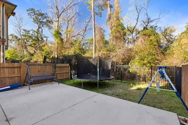 a view of a patio with a table and chairs under an umbrella