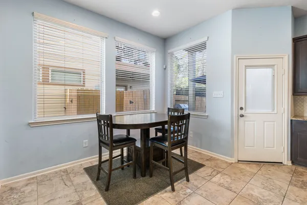 a kitchen with kitchen island granite countertop wooden cabinets and refrigerator