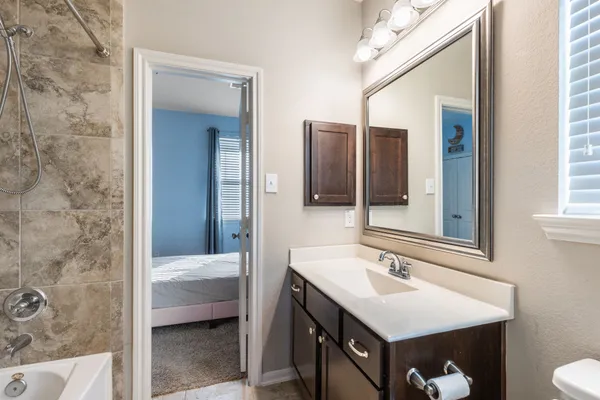 a bedroom with a bed and window