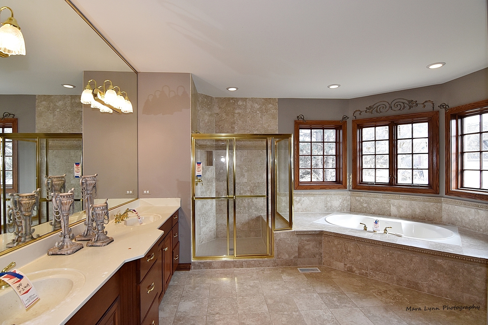 36W623 Lancaster Road St. Charles, IL 60175 - Photo 14 of 20 a spacious bathroom with a tub a double vanity sink a mirror and a shower