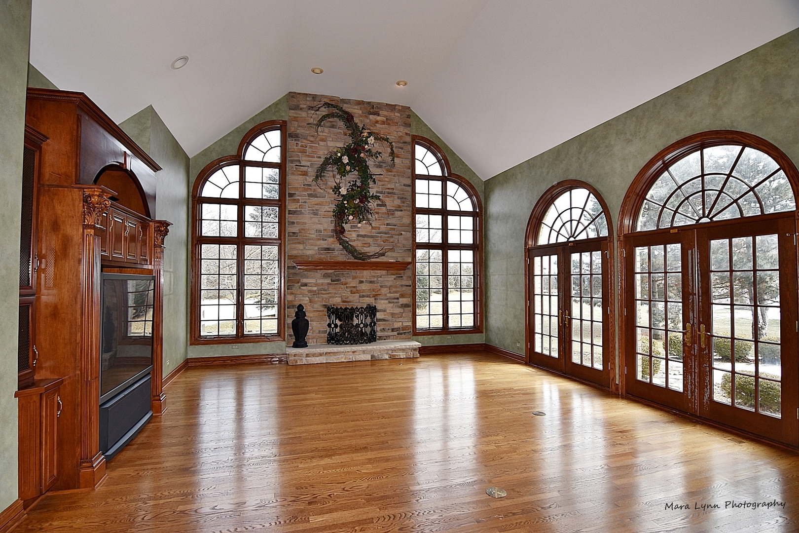 36W623 Lancaster Road St. Charles, IL 60175 - Photo 9 of 20 a view of an entryway with wooden floor and a fireplace