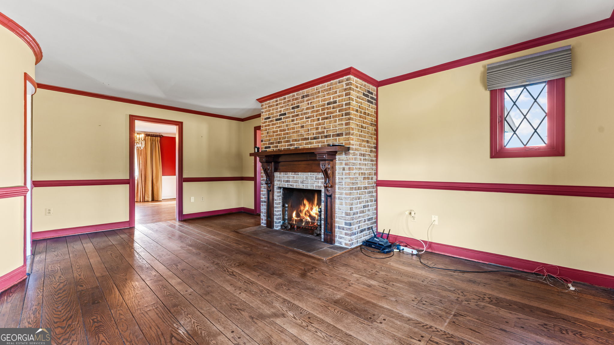 8876 Cave Springs Road Cave Spring, GA 30124 - Photo 11 of 36 a view of an empty room with wooden floor fireplace and a window
