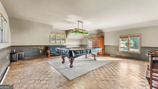 a living room with furniture and a dining table