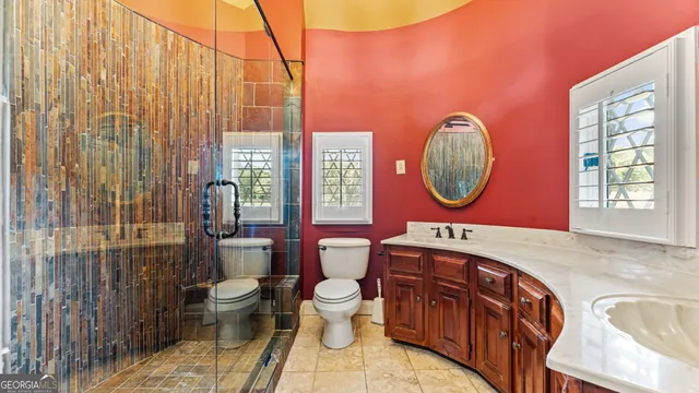 a bathroom with a toilet a sink and a mirror