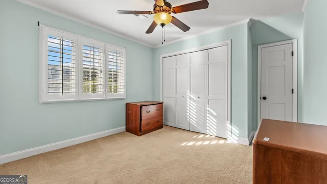 a view of a livingroom with a ceiling fan and window