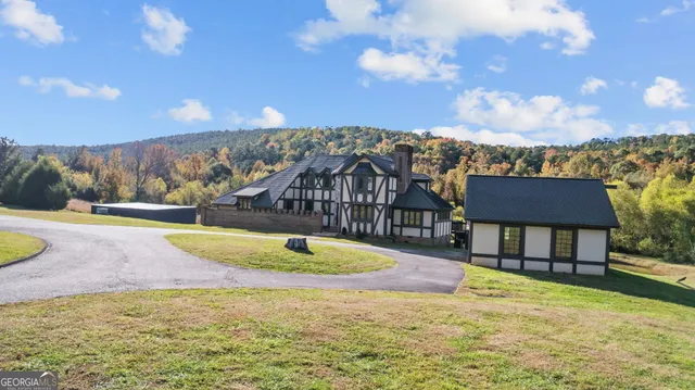a view of a swimming pool with an outdoor seating and a yard