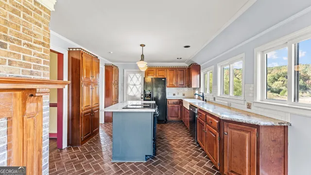 a large kitchen with granite countertop a large window and stainless steel appliances