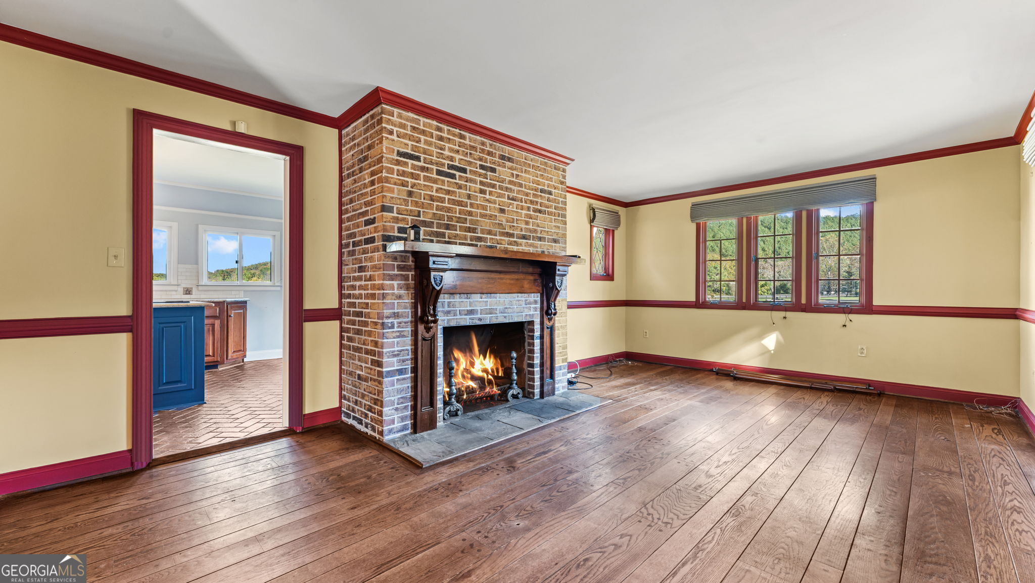 8876 Cave Springs Road Cave Spring, GA 30124 - Photo 10 of 36 a view of a livingroom with wooden floor and a fireplace