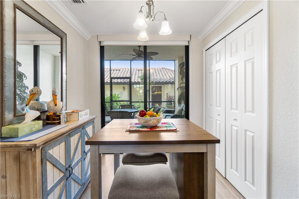 9525 Avellino Way, Unit 2615 Naples, FL 34113 - Photo 11 of 16 a view of a dining room with furniture window and outside view