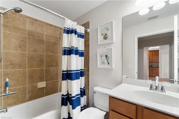 a bathroom with a sink toilet vanity and shower