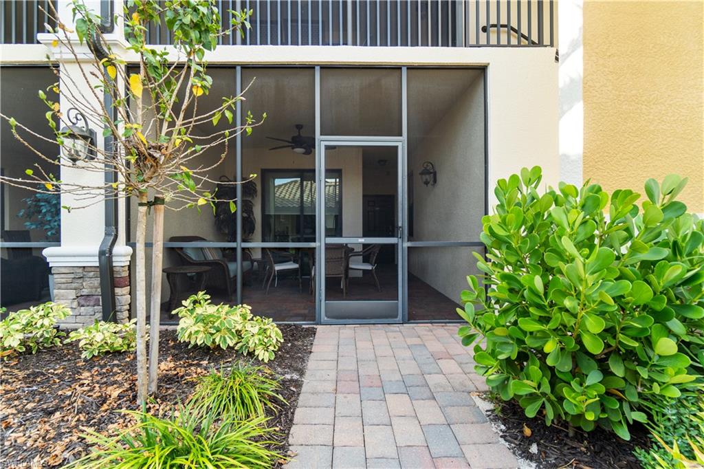 9525 Avellino Way, Unit 2615 Naples, FL 34113 - Photo 15 of 16 a front view of a house with a garden