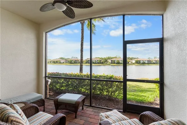 a balcony with furniture and a large window